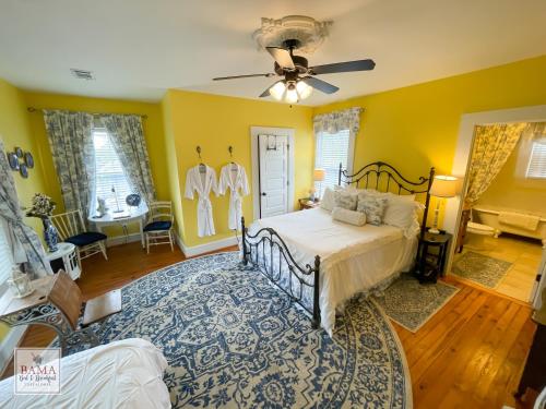 a bedroom with a bed and a ceiling fan at Bama Bed and Breakfast - Capstone Suite in Tuscaloosa