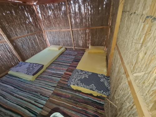 a small room with two beds in a yurt at Happy Camp in Nuweiba