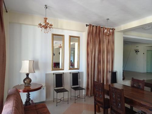 a living room with a couch and a table and a mirror at Elimeia 3 Hotel in Aiani