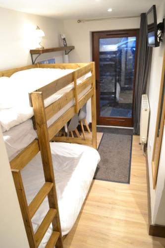a couple of bunk beds in a room at Dalecote Barn Bed and Breakfast (Bunkroom) in Ingleton