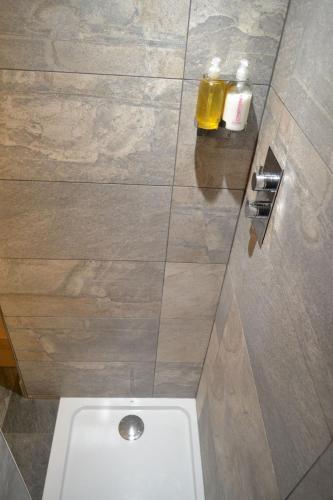 a toilet in a bathroom with a tile floor at Dalecote Barn Bed and Breakfast (Bunkroom) in Ingleton