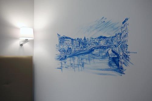 a drawing of a bridge on a wall next to a lamp at Casual Gurea in Bilbao