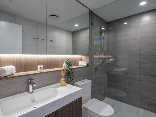 a bathroom with a toilet and a sink and a shower at The Star Residences - Gold Coast in Gold Coast