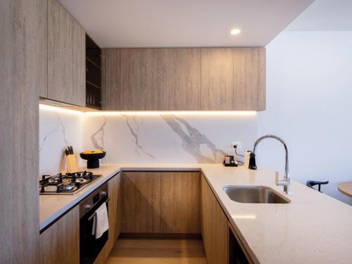 a kitchen with a sink and a stove top oven at The Star Residences - Gold Coast in Gold Coast