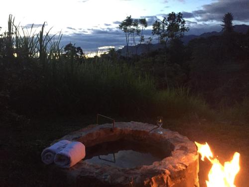 a fire pit in a field with flames at Glamping El Árbol en la Casa in San Antonio del Tequendama