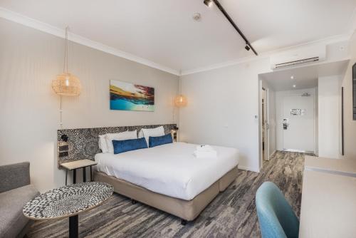 a hotel room with a bed and a couch at Nightelier Mermaid Waters in Gold Coast