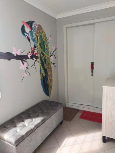 a mural of a parrot on a wall in a room at CMK APARTMEN MUTIARA TOWER 3 BEDROOM KOTA BHARU#Netflix in Kota Bharu