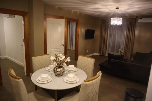 
a living room with a table and chairs at Empire Apartments SU 2 Marthastraat in Paramaribo

