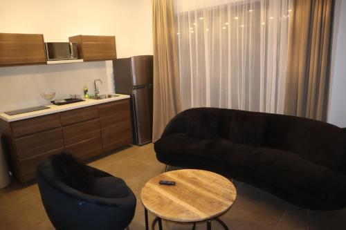 a living room with a couch and a table at Empire Apartments SU 2 Marthastraat in Paramaribo