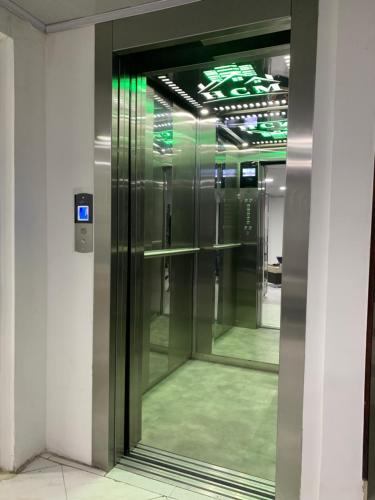 a glass elevator in a building with green lights at Hotel Casa Modelia in Bogotá