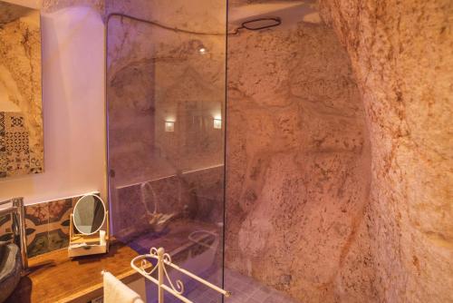 a shower with a glass door in a bathroom at Via Roma 32 in Ostuni