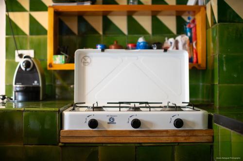 a white stove top oven sitting on a kitchen counter at Cal Cambrot in Bagá