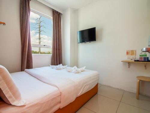 Postel nebo postele na pokoji v ubytování 1 Hotel Taman Connaught