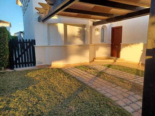 a house with a porch and a door on it at Fantastica villa con piscina en gran golf resort in Roldán