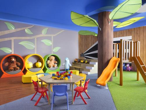 a childrens play room with a table and chairs at InterContinental Bandung Dago Pakar by IHG in Bandung