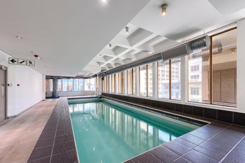 a swimming pool with green water in a building at #1803 Cartwright - Simply Spectacular in Cape Town