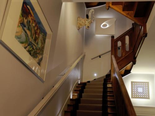 a staircase in a house with a painting on the wall at Le 27- Boutique B&B in Dinan
