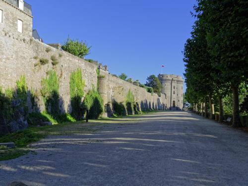 an empty street in front of a stone wall at Le 27- Boutique B&B in Dinan