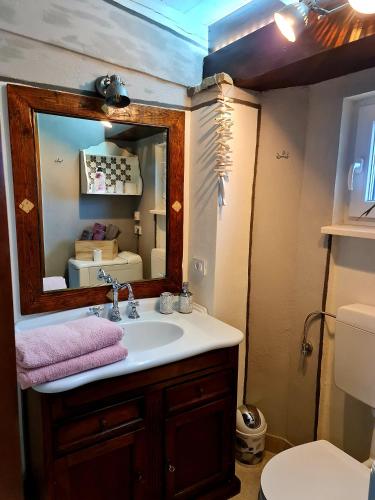 a bathroom with a sink and a mirror at CASA VILLANOVA homes in Nova Vas nad Dragonjo