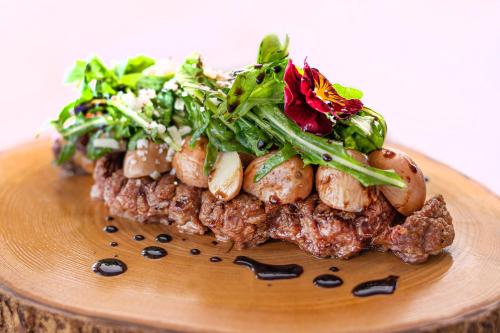 a plate of food with meat and vegetables on it at Mövenpick Hotel & Residences Nairobi in Nairobi