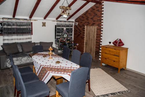 a living room with a table and a christmas tree at Cabana „Stâna din Deal” in Proviţa de Sus