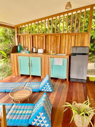 an outdoor kitchen with blue cabinets and a counter at Kalulushi Bungalows in Haad Pleayleam