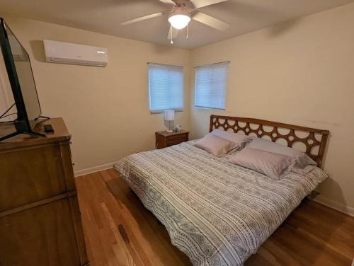 a bedroom with a bed and a ceiling fan at Warm and Welcoming 2BR close to UNM North Campus in Albuquerque