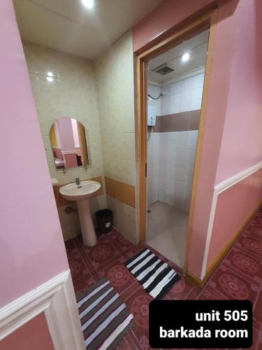 a small bathroom with a sink and a shower at ASHBURN'S TRANSIENT BAGUIO - 3rd to 5th floor BASIC SLEEP and GO Accommodation, WITH PARKING, NO ELEVATOR in Baguio
