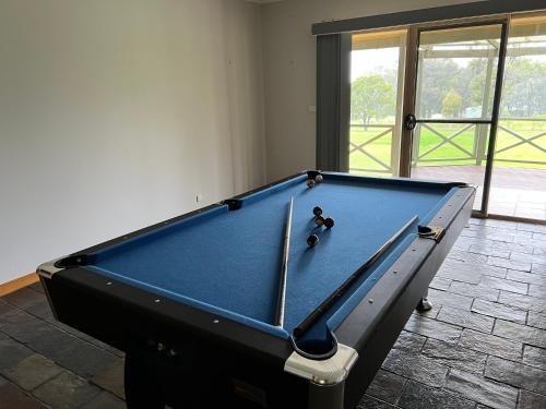 a pool table with a teddy bear sitting on it at Carinya Cottage Hunter Valley - Nature retreat in Aberdare