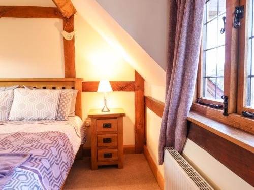 a bedroom with a bed and a window at The Old House in Llanidloes