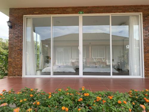 a large glass window on a house with a bedroom at Huyen's Home in Ba Ria