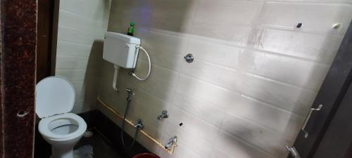 y baño con aseo blanco en una cabina. en Moray homestay, en Malvan