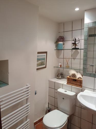a bathroom with a toilet and a sink at La Maison Provençale in La Roquebrussanne