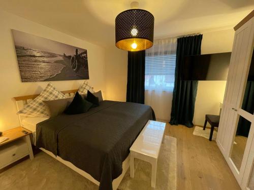 a bedroom with a bed and a table and a lamp at Ferienwohnung OutletCity in Metzingen