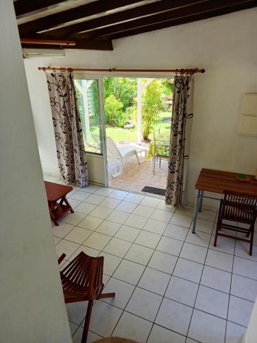 a view of a room with a table and chairs at Maison charmante Grand-Bourg in Grand-Bourg
