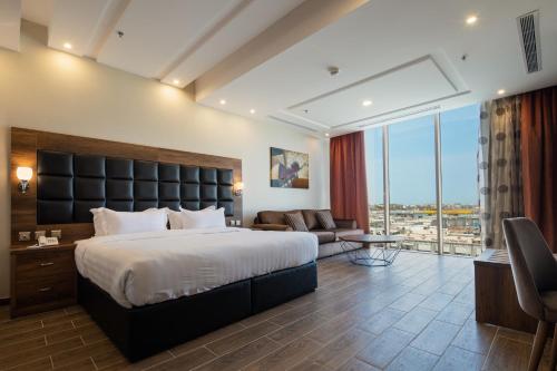 a hotel room with a bed and a large window at Mirada Purple - Zahra in Jeddah