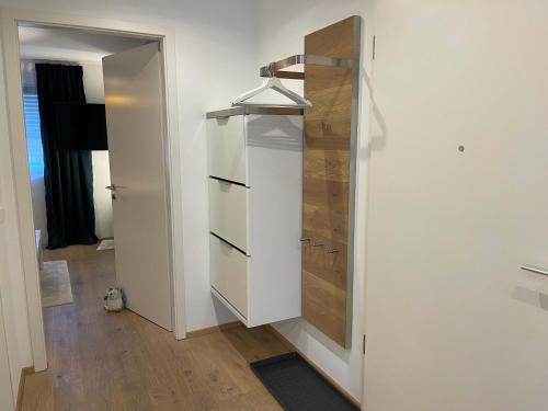 a white cabinet in a room with a door at Ferienwohnung OutletCity in Metzingen