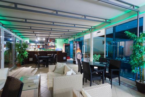 a restaurant with tables and chairs and a bar at Spa Resort Luxury Apartments in Budva