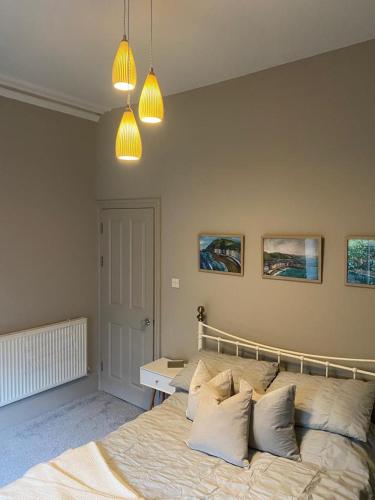a bedroom with a large bed with pillows on it at Lan Y Môr 4 Aberystwyth in Aberystwyth