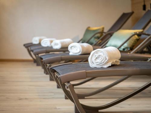 a row of chairs with white rolled towels on them at Hotel Tiroler Herz in Hinterhornbach