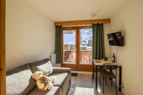 a living room with a couch and a table at CHALET CLUB VAL CLARET in Tignes