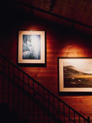 two framed photographs on a wall in a room at Gaustablikk Fjellresort in Gaustablikk
