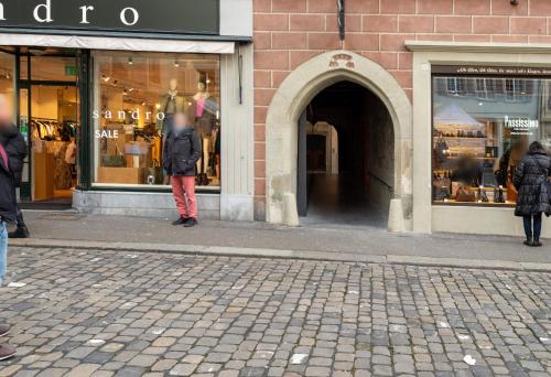 a person standing in front of a store window at HITrental Zur Metzgern Apartments in Luzern
