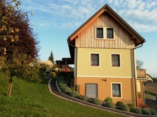 a yellow house with a brown roof at Ferienhaus Penitz in Großklein