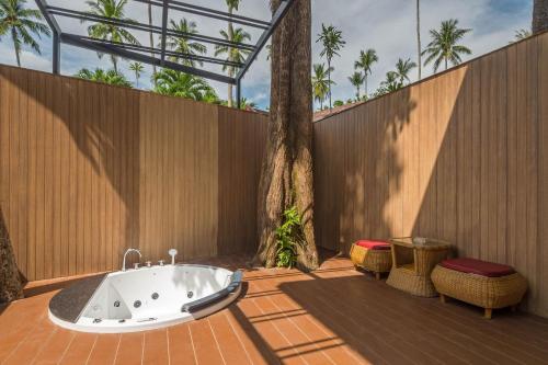 a bath tub sitting on a patio next to a fence at Aonang Paradise Resort Krabi in Ao Nang Beach