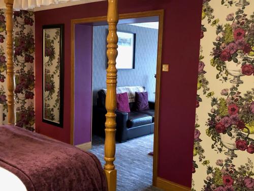 a bedroom with a bed and a mirror at Royal Court Hotel in Portrush