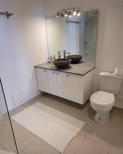 a bathroom with a toilet and a sink and a mirror at Hello Guyane(3), Suite Prestige Premium, 5 étoiles in Cayenne