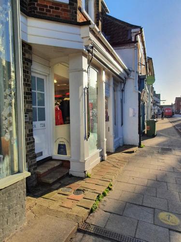 a street with a store on the side of a building at 72a High Street in Southwold