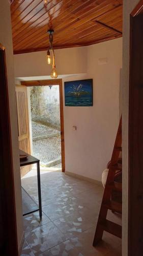 a living room with a wooden ceiling and a table at Art`Rio - Casa no Rio em Dornes in Dornes