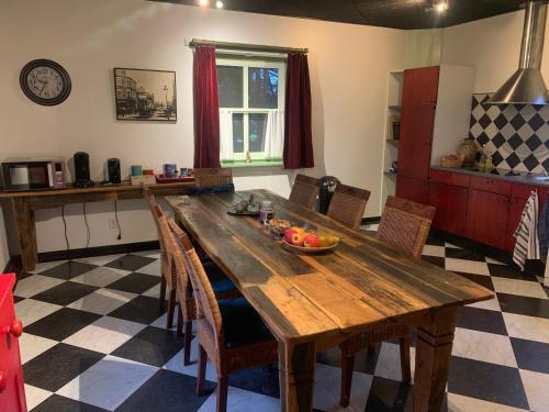 a wooden table in a kitchen with a bowl of fruit on it at B&B De Hooiberg Edam-Volendam in Edam